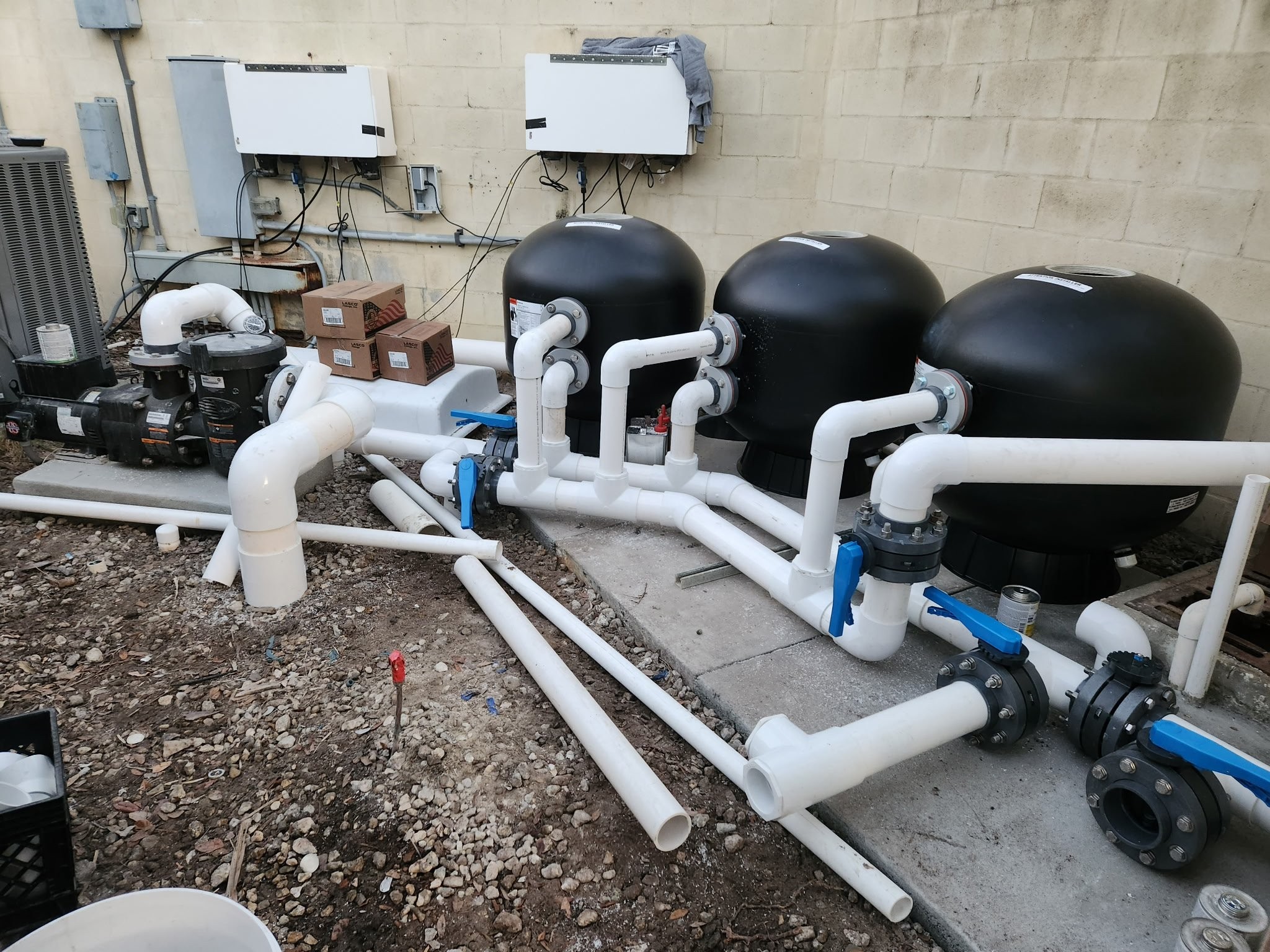 Commercial black-dome filter array with manifold piping and pump station