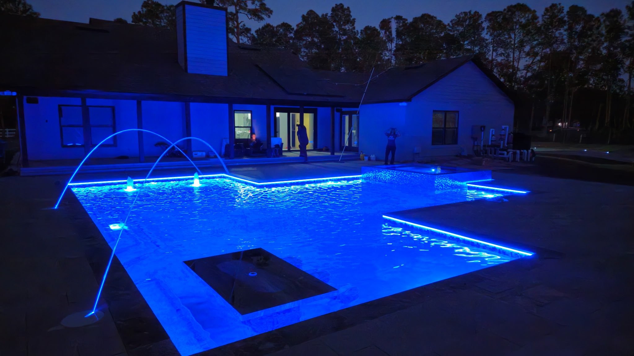Night pool with electric blue LED lighting, arc jets and outdoor entertaining