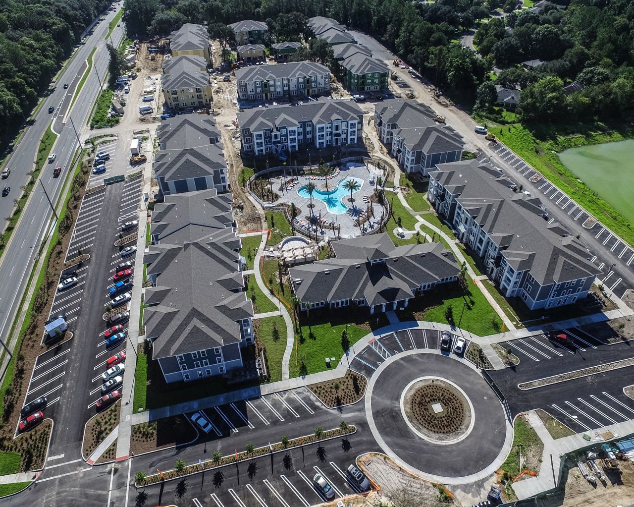 Aerial view of a multi-family apartment community in central Florida featuring an Arinton-built resort-style commercial pool and amenity area