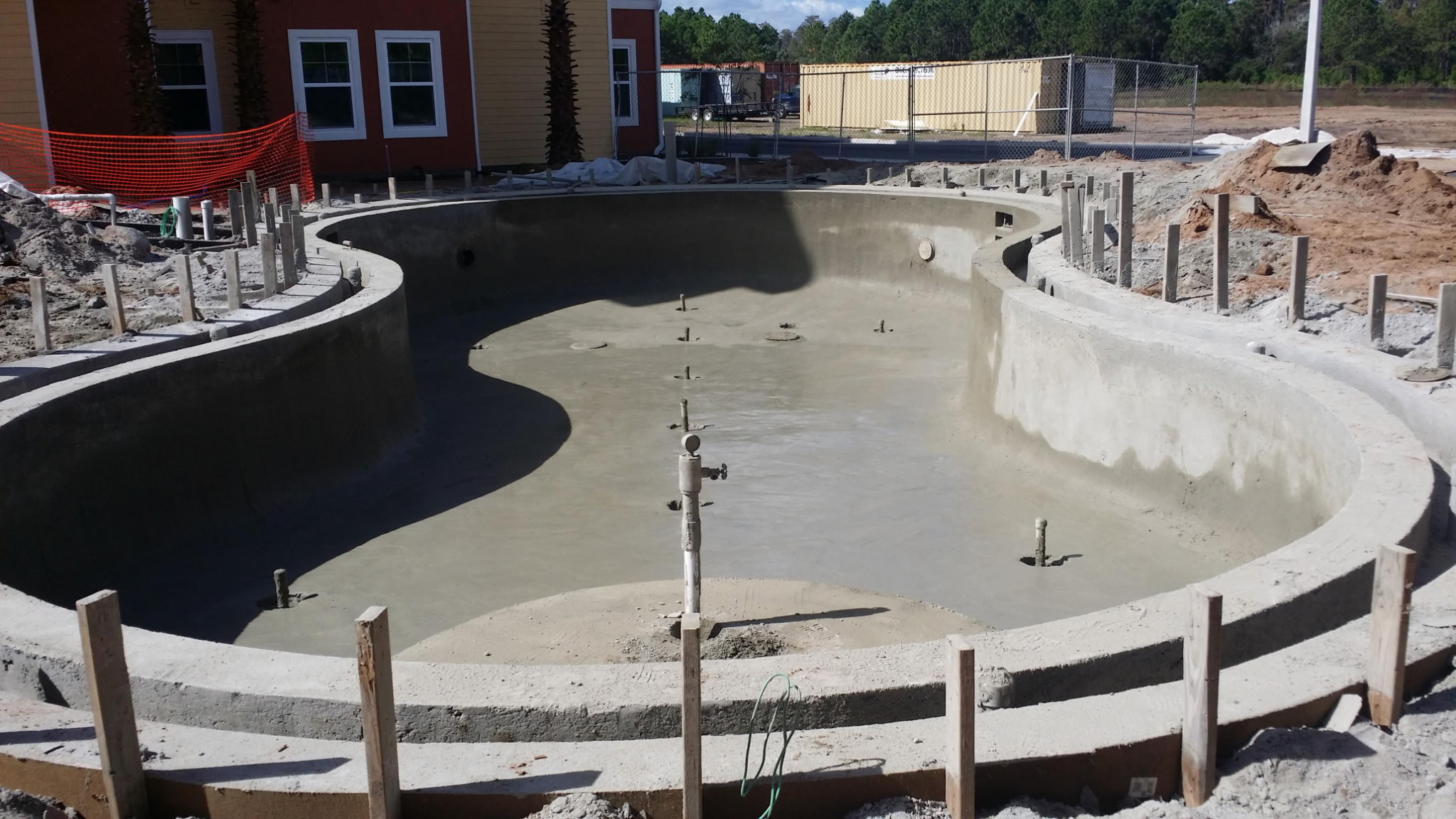 Shotcrete commercial pool shell freshly applied, freeform shape with steps and benches
